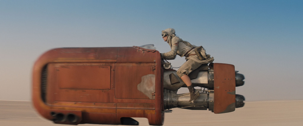 Rey zooms on her speeder through Jakku's desert. Image Credit: starwars.com